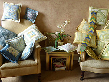 A photo of a selection of All Stitched Up's Needlepoint cushion designs